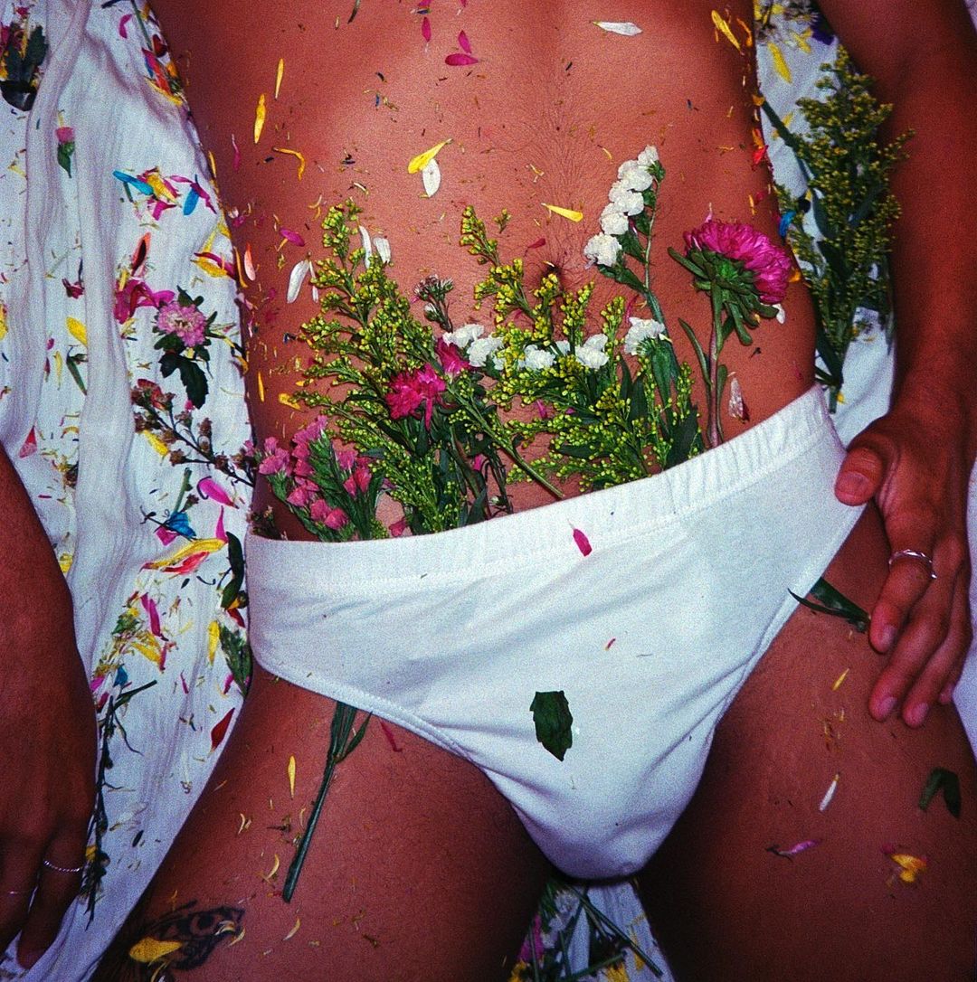 Person wearing white underwear with flowers in their underwear
